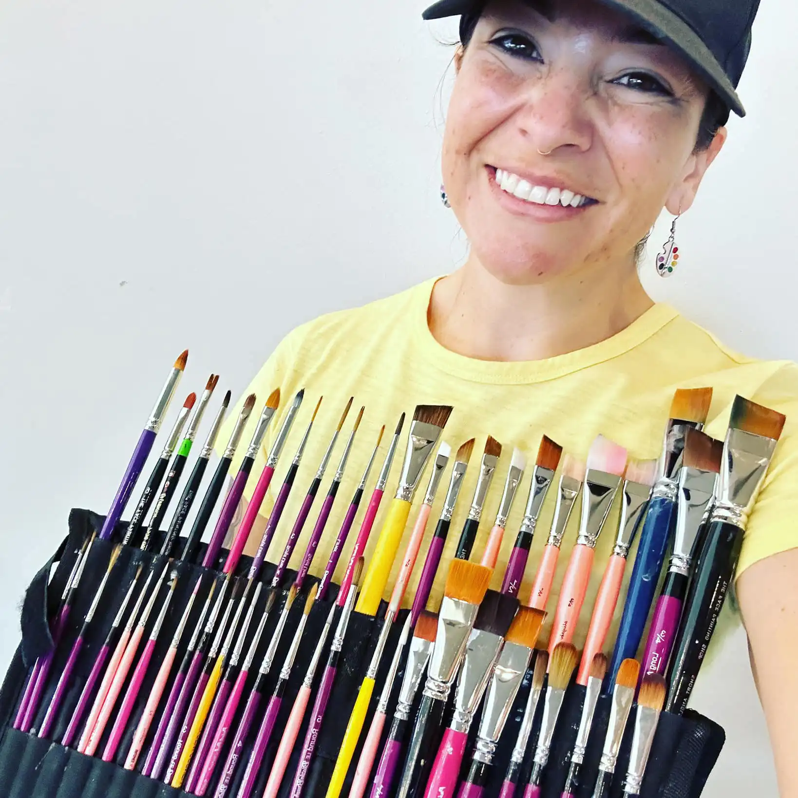 picture of Bee Lu and her many paint brushes for face painting
