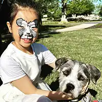 picture of a puppy mask face painting with real puppy